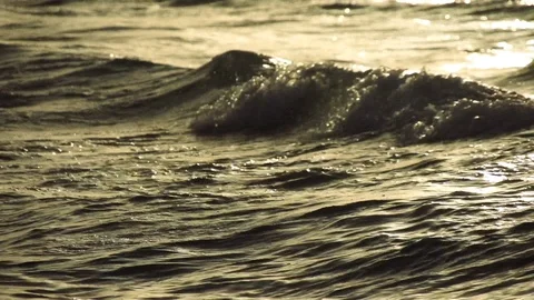 Focus throw onto waves at sunset Stock Footage 104380288