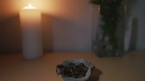 Focus transition of a burning candle and Rosary placed in the stone Stockbeeldmateriaal 233916985