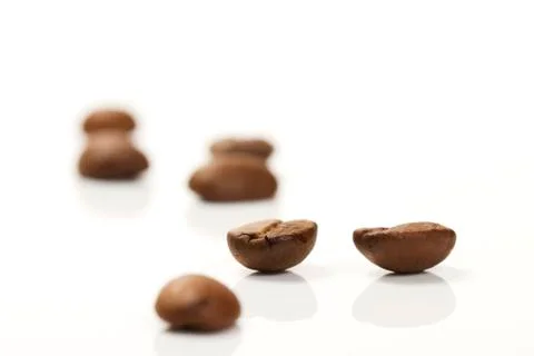 Focus on two coffee beans between others Stock Photos
