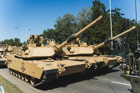 Focus on two M1 Abrams main battle tanks driving in a column during an open-air Stock Photos