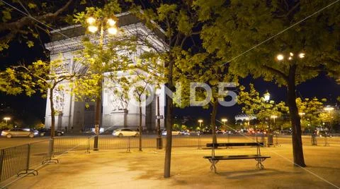 In focus view of Arc de Triomphe in Paris, France near street with traffic Stock Photos