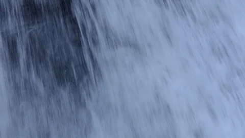 Focus the waterfall on the flow through the rocky cliffs on the way down. Stock-Footage 118497556