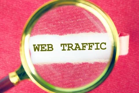 Focus on web traffic analysis using a magnifying glass to emphasize its impor Stock Photos