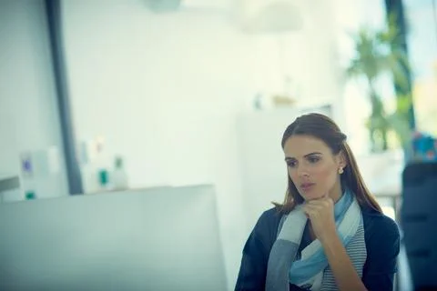 Focus will find a solution. a young businesswoman using a computer in a modern Stock Photos