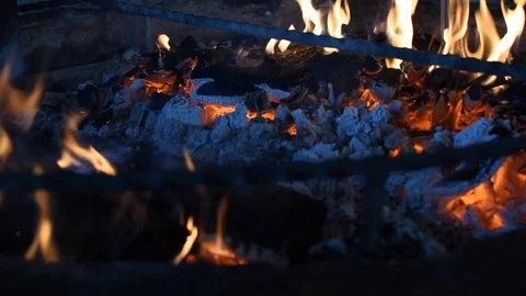 Focus of wood burning inside a fireplace. Fire playing around burned wood Stock Footage 123010294