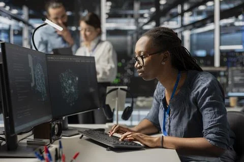 Focused admin in data center using AI powered tech to run simulations Stock Photos