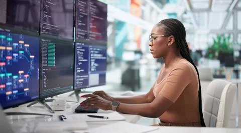 Focused African American Software Engineer Coding Secure Web Data At Busy Off Фото