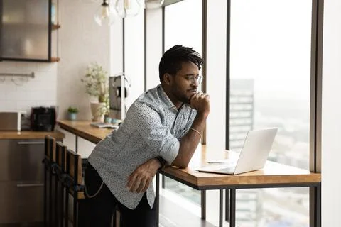 Focused afro american guy study web search result using laptop 写真素材