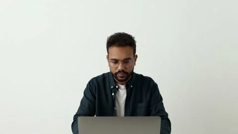Focused afro black guy working studying on wireless computer.Young man typing 4k Stock Footage 179957524
