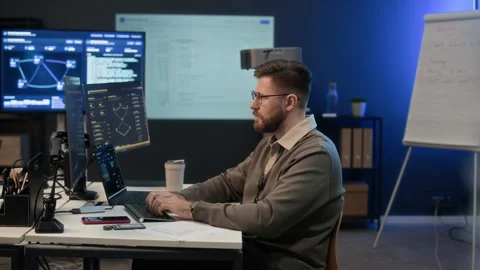 Focused Analyst Working on Computers in Network Center Stock Footage 334930127