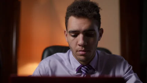 A Focused and Ambitious Young Man Diligently Working on His Laptop Stock Footage 291541677