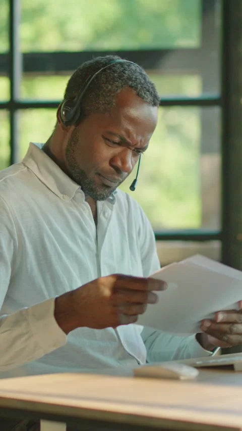 A Focused and Dedicated Professional Engaged in Work within a Modern Office Stock Footage 314361966