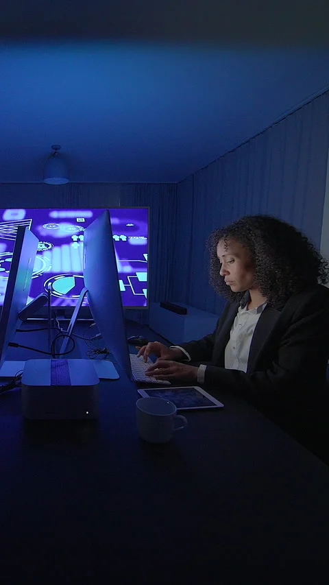 A Focused and Dedicated Professional Working Late into the Night in a Stock-Footage 296018006