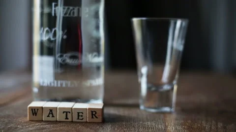 Focused and defocused a sparkling bottle of water with a glass, indoor Stock-Footage 56376941