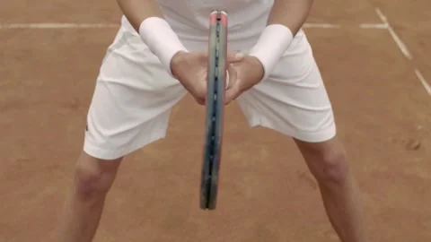 A focused and determined tennis player is getting ready for an impressive serve Stock Footage 285605703