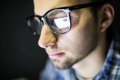 Focused and thoughtful man. Coder, programmer or developer using laptop in da Stock Photos