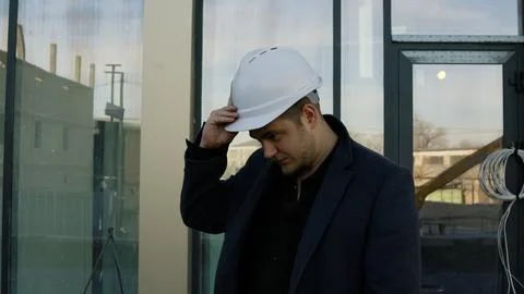 Focused architect engineer examines the building structure outdoors Stock-Fotos