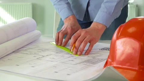 Focused architect meticulously drawing precise lines on a detailed design Stock Footage 311945587