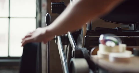 Focused artist creating a print with an old fashioned letterpress machine in int Stock Footage 199458097