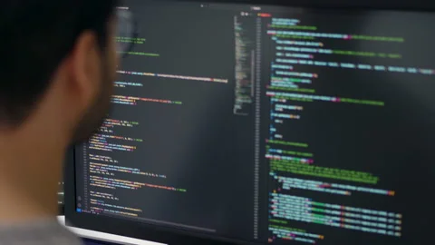 Focused Asian Male Programmer Coding on Multiple Monitors in Modern Office. Stock Footage 310589345