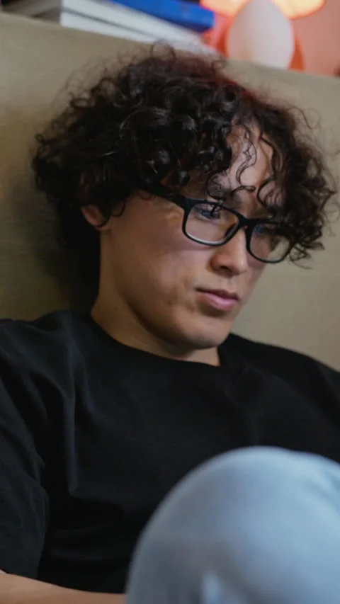 Focused Asian Man with Glasses Working Online from Home Video stock 338421477