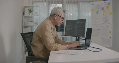 Focused Asian Senior Developer Working On Software Code At Modern Office Desk Stock Footage 308162293