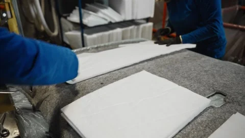 Focused Assembly Technician Carefully Installs Foam Panels Onto Fabric In Video stock 323799789
