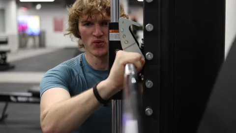 Focused athlete powers through a demanding cable machine exercise Stock Footage 339321579