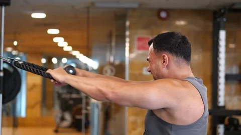Focused athletic man performing cable face pulls exercise with intense faci.. Stock-Footage 344032014