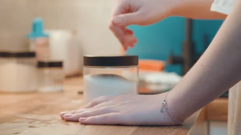 Focused baker measuring sugar near jar carefully. Dedicated baker concentrates 動画素材 345530157