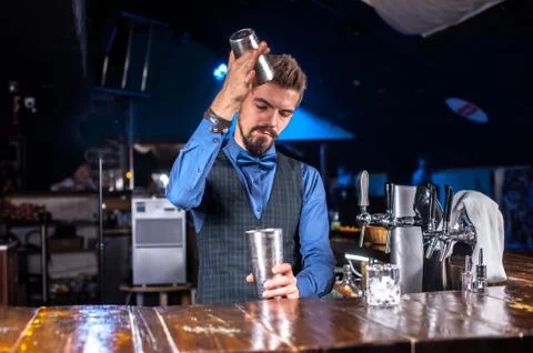 Focused bartending demonstrates the process of making a cocktail at the bar Foto stock
