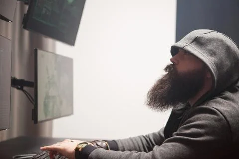 Focused bearded hacker to destroy the system Stock Photos