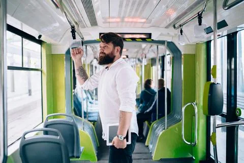 Focused bearded man with tablet in train Stock Photos