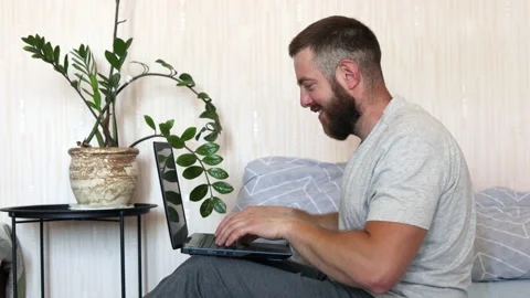 Focused bearded man typing on laptop doing research. Stock Footage 156704381