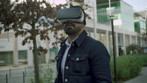 Focused bearded man using vr glasses on street Stock Footage 102550161