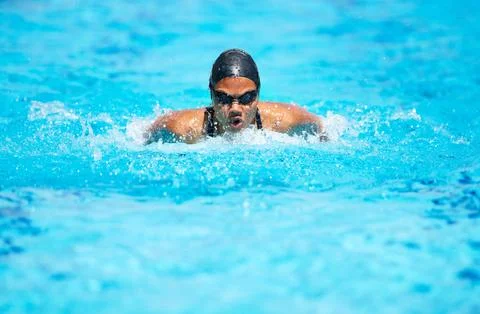 Focused on bettering her time. Determined young female swimmer swimming within Stock Photos