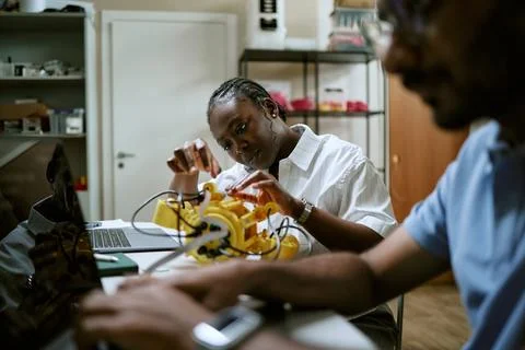 Focused Black Female Engineer Assembling Robotics Device in Modern Lab Stock Photos