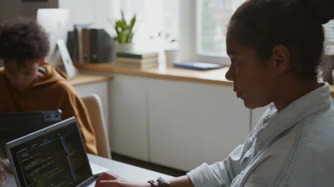 Focused Black Girl Typing Computer Code on Laptop at Practical Lesson Video stock 318721293