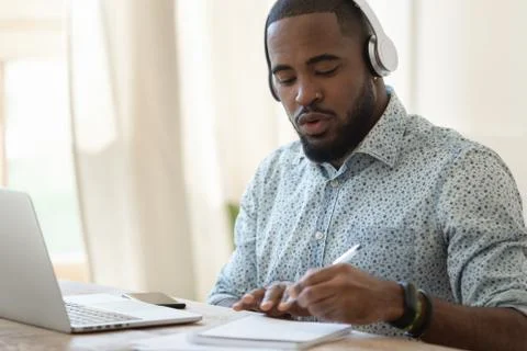 Focused black guy busy with certification training. 写真素材