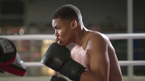 Focused boxer improving attack skills with a coach Stock Footage 197380664