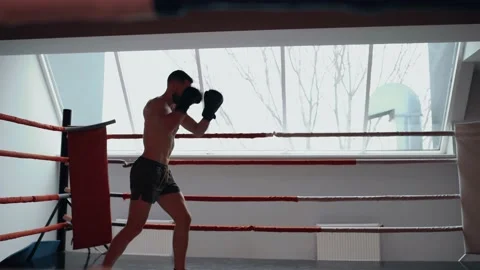 The focused boxer trains on the dance floor, prepares for the next fight Video stock 156470577