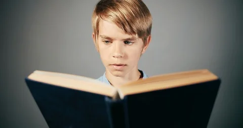 Focused Boy Reading Book Isolated 库存影片 115327341
