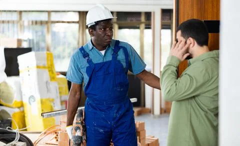 Focused builders posing on indoor construction site Stock Photos