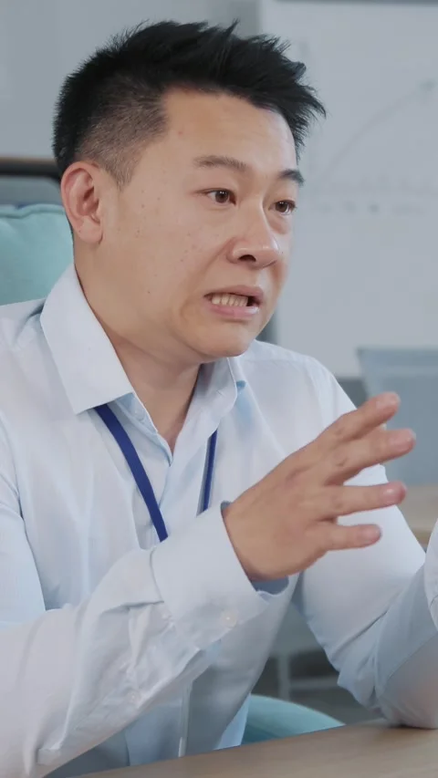 A Focused Business Professional Working on a Computer in a Modern Office Setting Stock Footage 314359626