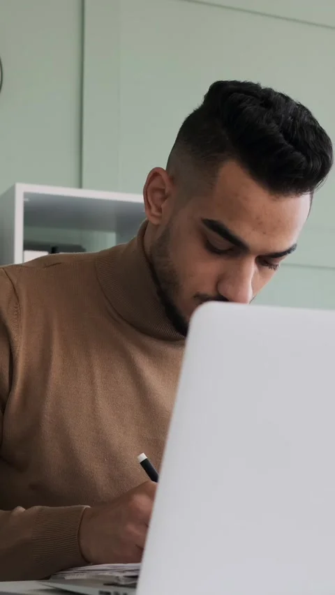 Focused Businessman Analyzing Documents and Using Laptop at Office Desk Stock Footage 326639667