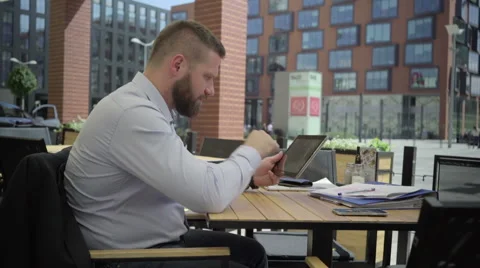 Focused businessman browsing tablet in cafe, steadicam. 動画素材 66332297