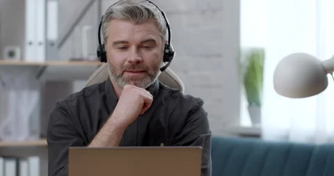 Focused Businessman in Headset makes Webcam calling Talking using Laptop Stock Footage 152397589
