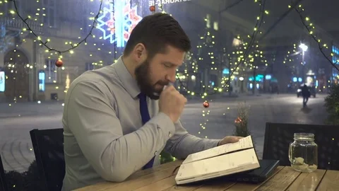 Focused businessman make notes after work, look at camera, cafe, christmas 動画素材 72999543