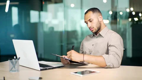Focused businessman manager watching educational video on computer, writing note Stock Footage 255972659