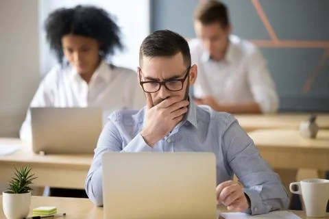 Focused businessman solving online problem working on laptop in Stock Photos